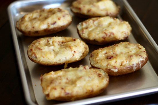 Twice baked potatoes are a favorite dinner side. Baked to perfection with butter, bacon, cheese and sour cream. How can you go wrong? | sarahnspice.com
