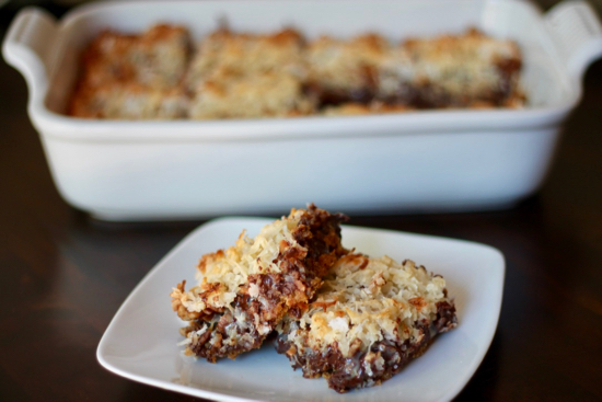 Magic Bars have a soft graham cracker crust layered with chocolate, pecans, and coconut. These ooey gooey treats are irresistible. Try to eat just one! | sarahnspice.com