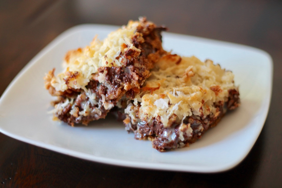 Magic Bars have a soft graham cracker crust layered with chocolate, pecans, and coconut. These ooey gooey treats are irresistible. Try to eat just one! | sarahnspice.com