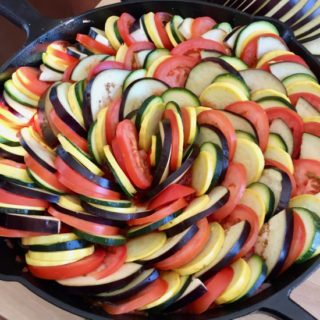 Ratatouille is an array of colorful vegetables on top of a savory tomato sauce, baked to perfection. A hearty dish that's as tasty as it is stunning! | sarahnspice.com
