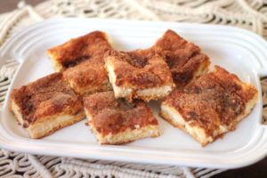 These Sopapilla Cheesecake Bars are dangerously delicious with a sweet cream cheese filling surrounded by crescent dough and sprinkled with cinnamon sugar. | sarahnspice.com